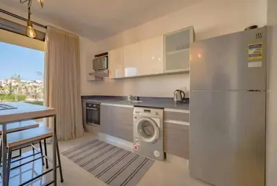 a kitchen with a stainless steel refrigerator and a dishwasher at Luxury Stays in G-Cribs El Gouna in El Gouna