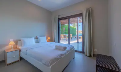 a bedroom with a bed and a sliding glass door at Luxury Stays in Sabina El Gouna in Hurghada