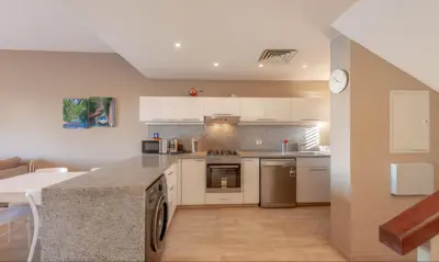 a kitchen with white cabinets and a counter top at Luxury Stays in Sabina El Gouna in Hurghada