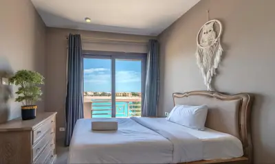 a bedroom with a bed and a window with a view at Luxury Stays in Sabina El Gouna in Hurghada