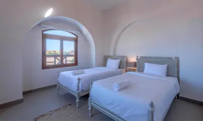 a bedroom with two beds and a window at Luxury Stays in Sabina El Gouna in Hurghada