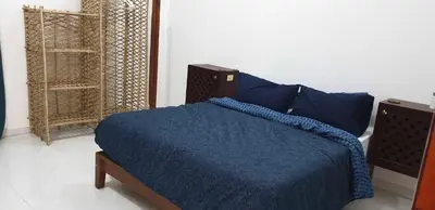 a bedroom with a blue bed with a blue blanket at Jahmed Country Villa Luxor West Bank in Al Aqālitah