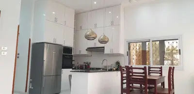 a kitchen with a refrigerator and a table and chairs at Jahmed Country Villa Luxor West Bank in Al Aqālitah