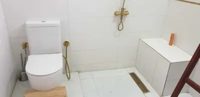a white bathroom with a toilet and a shower at Jahmed Country Villa Luxor West Bank in Al Aqālitah