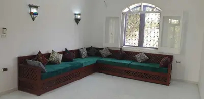 a green couch in a room with a window at Jahmed Country Villa Luxor West Bank in Al Aqālitah