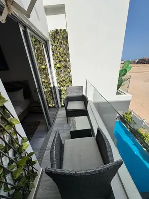 an outdoor patio with chairs and tables on a building at Studio 511 imperial resort in Hurghada