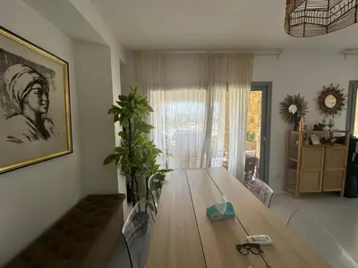 a living room with a wooden table in a room at Ground Modern Apartment in Hurghada