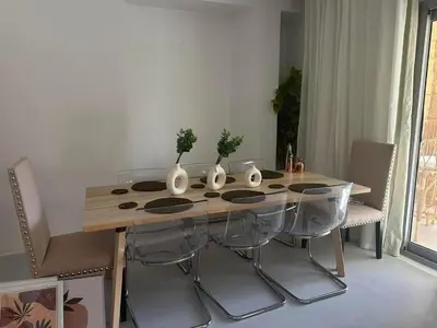 a dining room table with vases on top of it at Ground Modern Apartment in Hurghada
