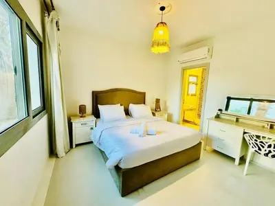 a bedroom with a bed with two candles on it at Ground Modern Apartment in Hurghada