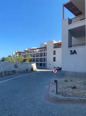 a building with a street sign in front of it at Breeze, Golf & Sea, 2 BR Luxury Apt with Terrace, Somabay in Hurghada