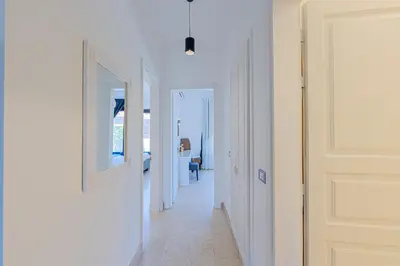 a hallway with two mirrors and a white door at Modern 2 bedroom apartment in El Gouna with pool in Hurghada