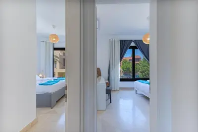 a view of a bedroom with two beds and a window at Modern 2 bedroom apartment in El Gouna with pool in Hurghada