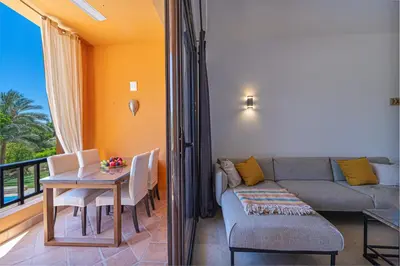 a living room with a table and a couch at Modern 2 bedroom apartment in El Gouna with pool in Hurghada
