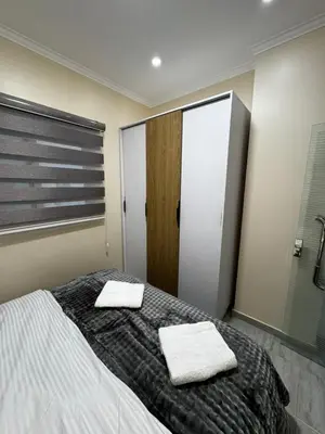 a bedroom with a bed with two towels on it at Aqua Palms Resort Hurghada in Hurghada