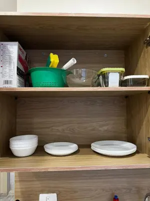 a wooden shelf with plates and bowls on it at Aqua Palms Resort Hurghada in Hurghada