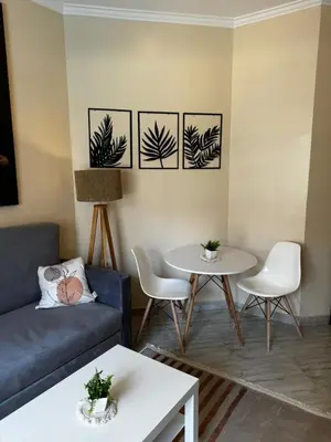 a living room with a couch and a table at Aqua Palms Resort Hurghada in Hurghada