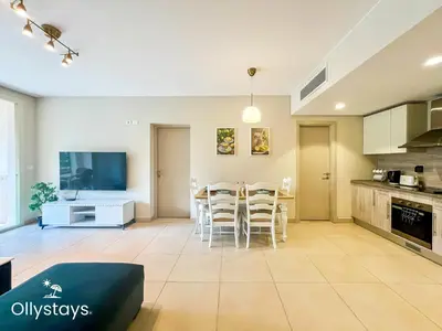 a kitchen and dining room with a table and chairs at Ollystays Mangroovy Seaview 1BR Beach and Pool Free access in Hurghada