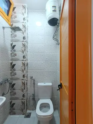 a small bathroom with a toilet and a sink at New El Amin Guesthouse in Aswan