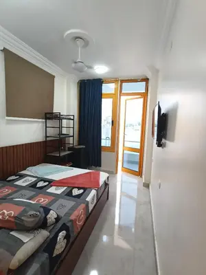 a bedroom with a bed and a sliding glass door at New El Amin Guesthouse in Aswan