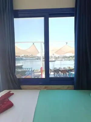 a bedroom with a window with a view of the water at New El Amin Guesthouse in Aswan