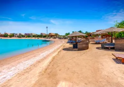 a beach with chairs and umbrellas on it at Luxury Stays in Nubia El Gouna in Hurghada