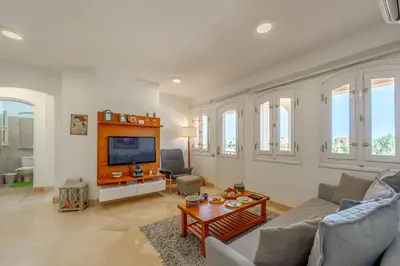 a living room with a couch and a tv at Luxury Stays in Nubia El Gouna in Hurghada