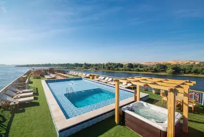 an outdoor pool with a view of the water at 4 nighhts luxury Nile cruise from Luxor to Aswan in Qena