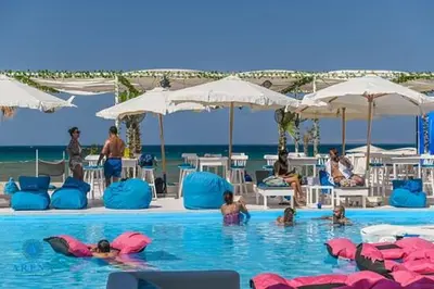 a group of people in a swimming pool at the beach at SELENA BAY Luxury Suite beach front hurghada Arena Bar & restaurant سويت فاخر سيلينا باى in Hurghada