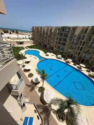 an overhead view of a large swimming pool in a building at Luxury Suite Princess Resort Two bedroom apartment Hurghada سويت فاخر البرنسيسه غرفتين in Hurghada