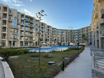 a large apartment building with a swimming pool at Luxury Suite Princess Resort Two bedroom apartment Hurghada سويت فاخر البرنسيسه غرفتين in Hurghada