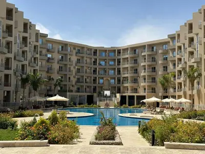 a large apartment building with a swimming pool at Luxury Suite Princess Resort Two bedroom apartment Hurghada سويت فاخر البرنسيسه غرفتين in Hurghada