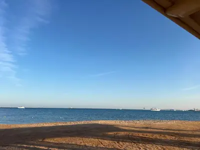 a view of the beach with boats in the water at Luxury Suite Princess Resort Two bedroom apartment Hurghada سويت فاخر البرنسيسه غرفتين in Hurghada
