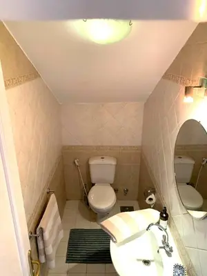 a bathroom with a toilet and a sink and a mirror at Coral Blue 'An expansive spacious 4 bedroom villa in El Gouna' in Hurghada