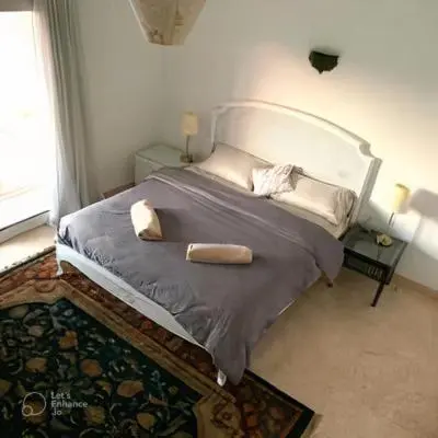 a bedroom with a bed with two pillows on it at Coral Blue 'An expansive spacious 4 bedroom villa in El Gouna' in Hurghada