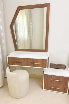 a bathroom with a mirror and a white stool at Modern apartments by the Red Sea in Hurghada