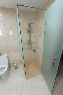 a bathroom with a shower and a toilet at Modern apartments by the Red Sea in Hurghada
