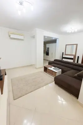 a living room with a couch and a table at Modern apartments by the Red Sea in Hurghada