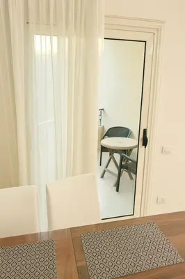 a room with a table and chairs and a mirror at Modern apartments by the Red Sea in Hurghada