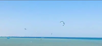 a kite flying in the sky over the ocean at فندق فنادير باي in Hurghada