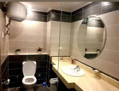 a bathroom with a toilet and a sink and a mirror at فندق فنادير باي in Hurghada