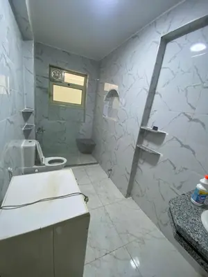 a white bathroom with a sink and a toilet at king tut apartment in Luxor