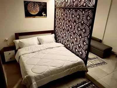 a bedroom with a bed with a head board at Hurghada Studio Tiba Golden Resort in Hurghada