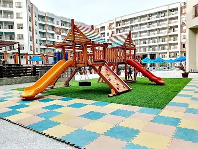 a playground with a slide on the grass at Hurghada Studio Tiba Golden Resort in Hurghada