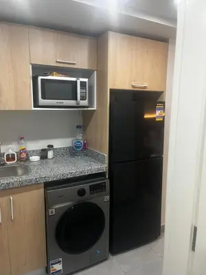 a kitchen with a black refrigerator and a microwave at Scandic resort chalet sea view in Hurghada