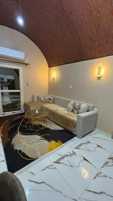 a living room with a couch and a table at Top in Hurghada