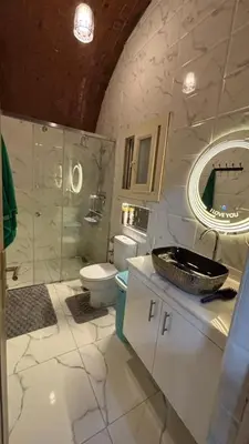 a bathroom with a sink and a toilet and a mirror at Top in Hurghada