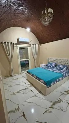 a bedroom with a bed on a marble floor at Sun Roof in Hurghada
