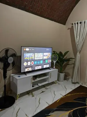 a living room with a flat screen tv on a stand at Sun Roof in Hurghada