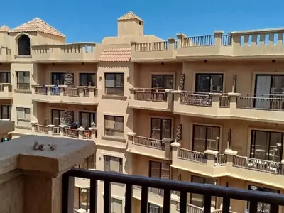 a view of an apartment building with balconies at Cozy Chalet , Turtles , Side Sea View in Hurghada