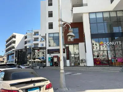 a car parked on a street in front of a building at La Prestigia chalet in Hurghada